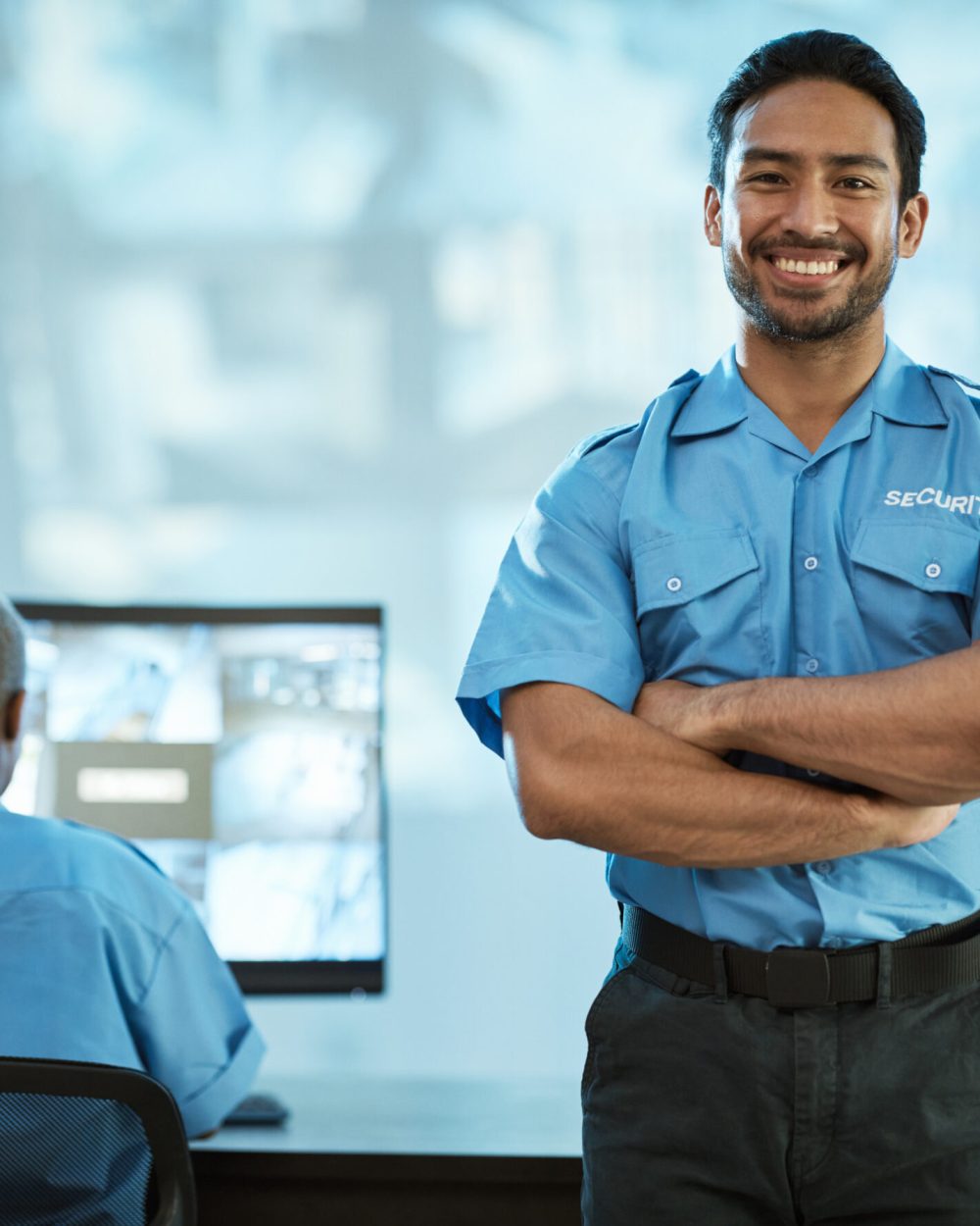 Portrait, security and man with smile in control room as employee at agency with asian. Face, safety, professional and working at data centre for surveillance for crime on video with technology